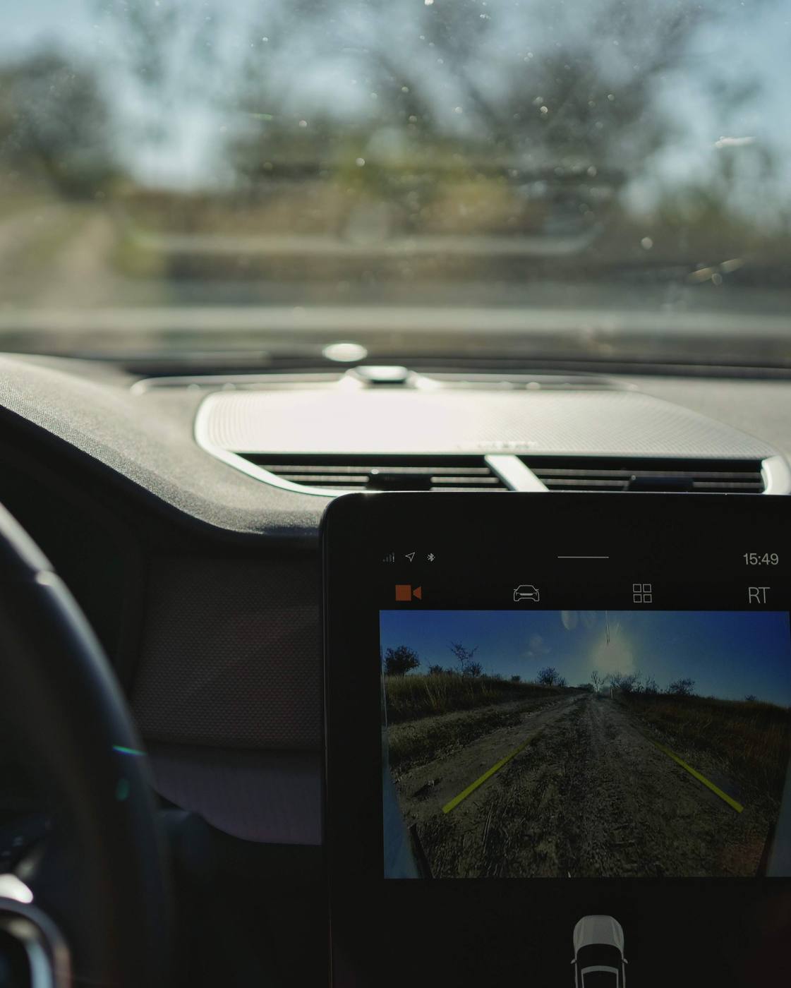 The centre screen, showing the rear camera on the dirt road