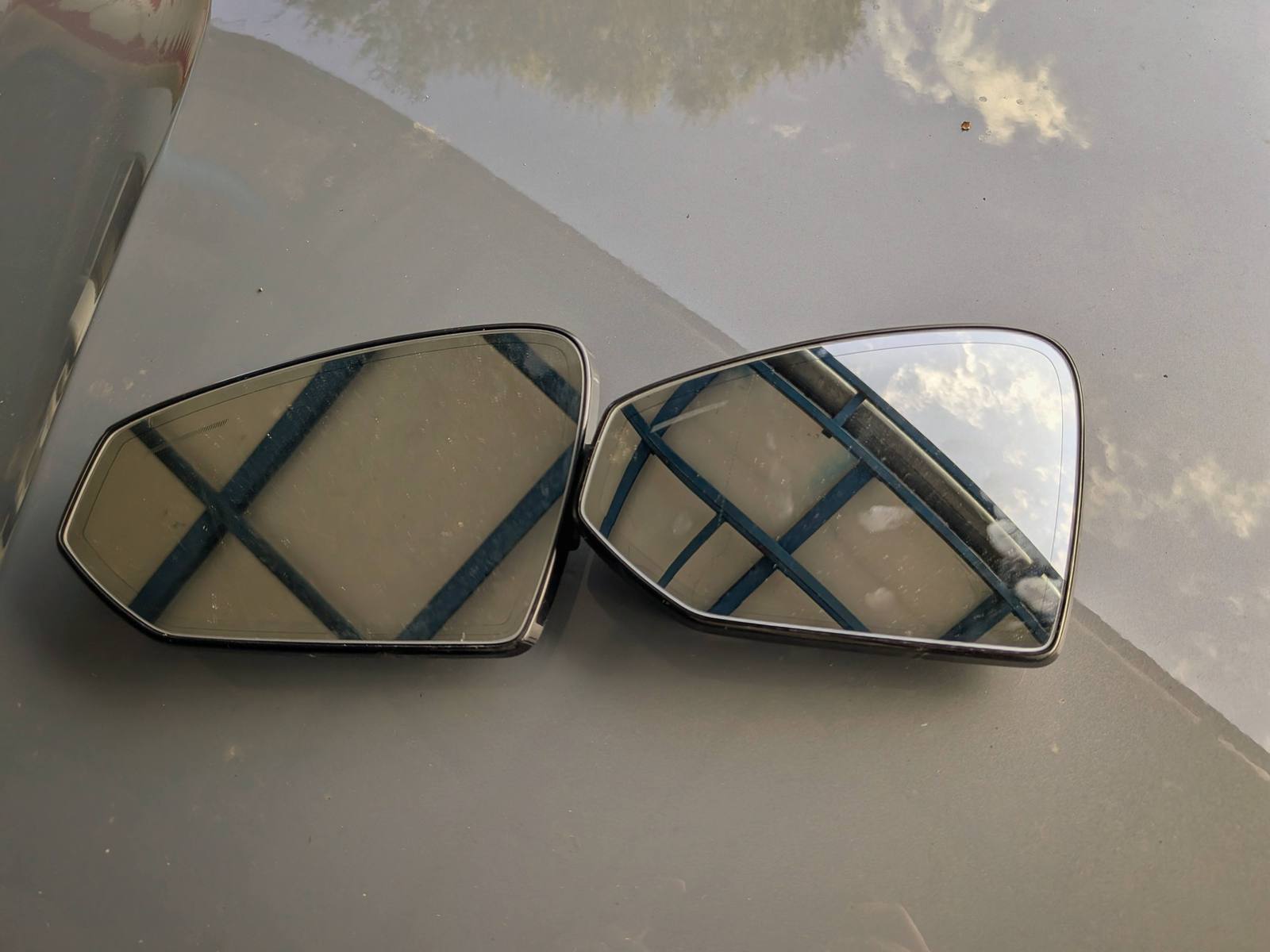 The two glasses on the bonnet: the flat American one on the left, the aspheric European one on the right
