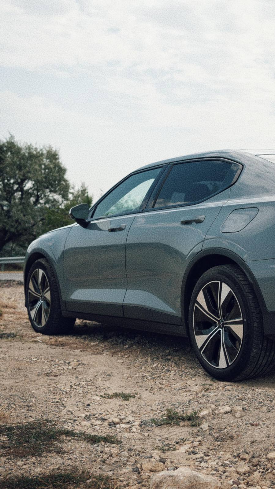 The side profile of the car on gravel